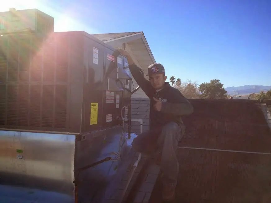 HVAC technician performing HVAC Inspection on a rooftop unit in Catskill